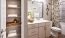 a bathroom with a sink toilet and shelves