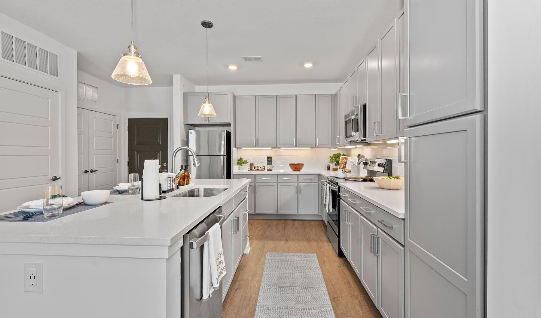 a kitchen with grey cabinets