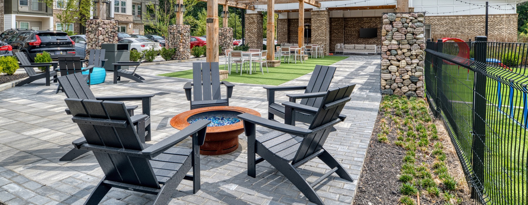 Adirondack chairs near a fire pit