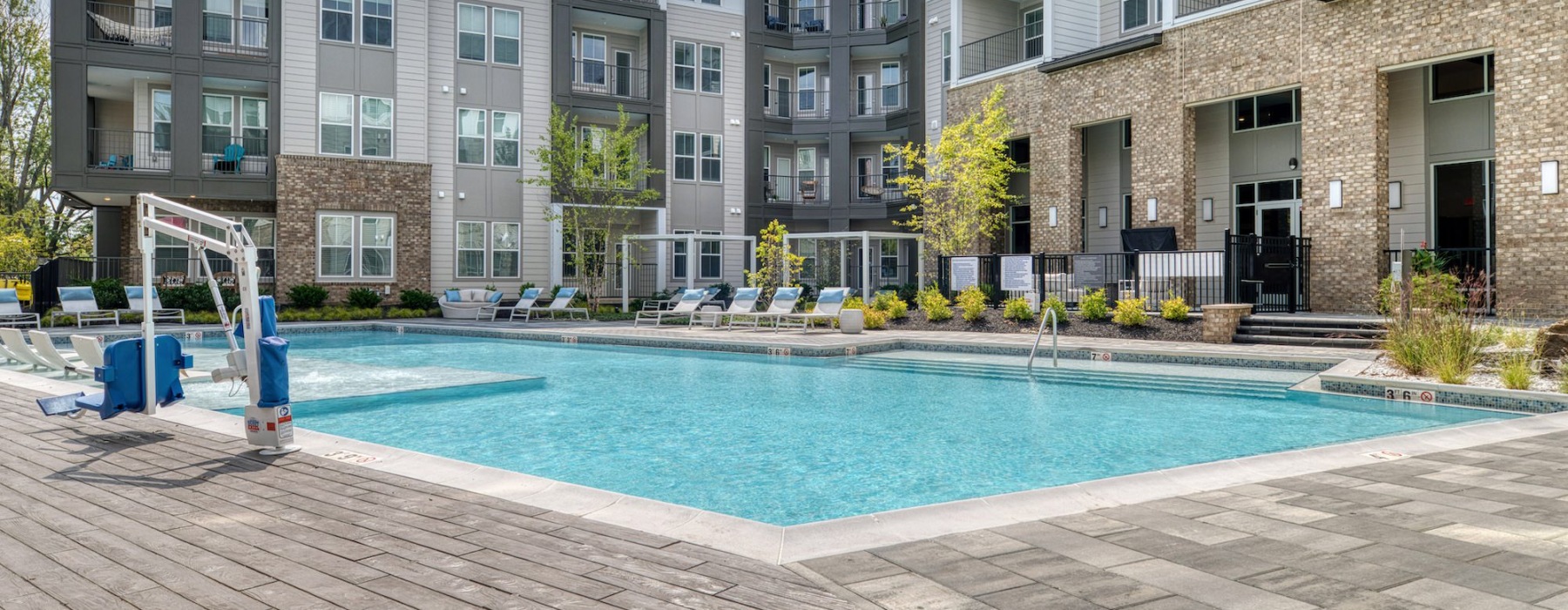 Resort-style swimming pool with lounge seating