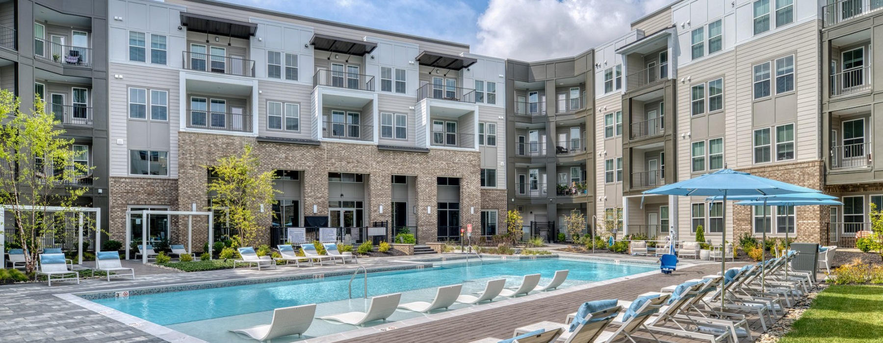 Resort-style swimming pool with lounge seating