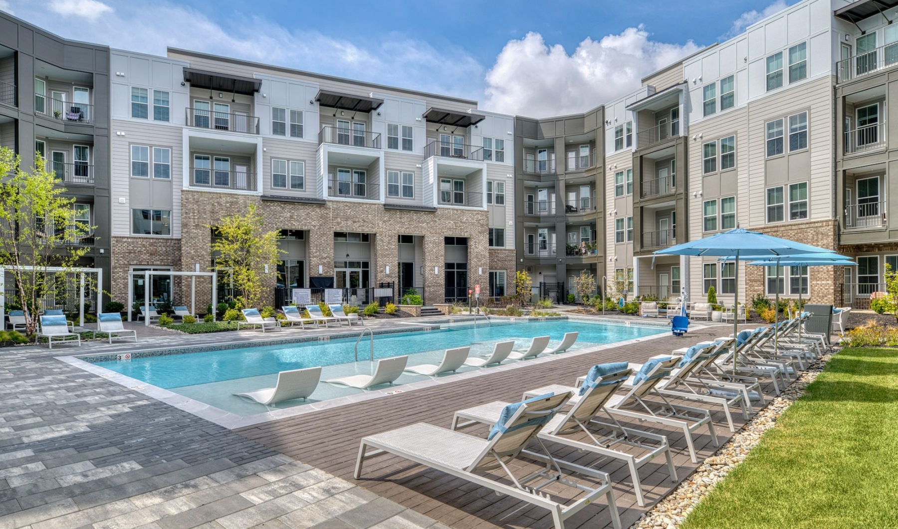 Resort-style swimming pool with lounge seating