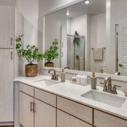 a spacious bathroom with a large mirror and ample light